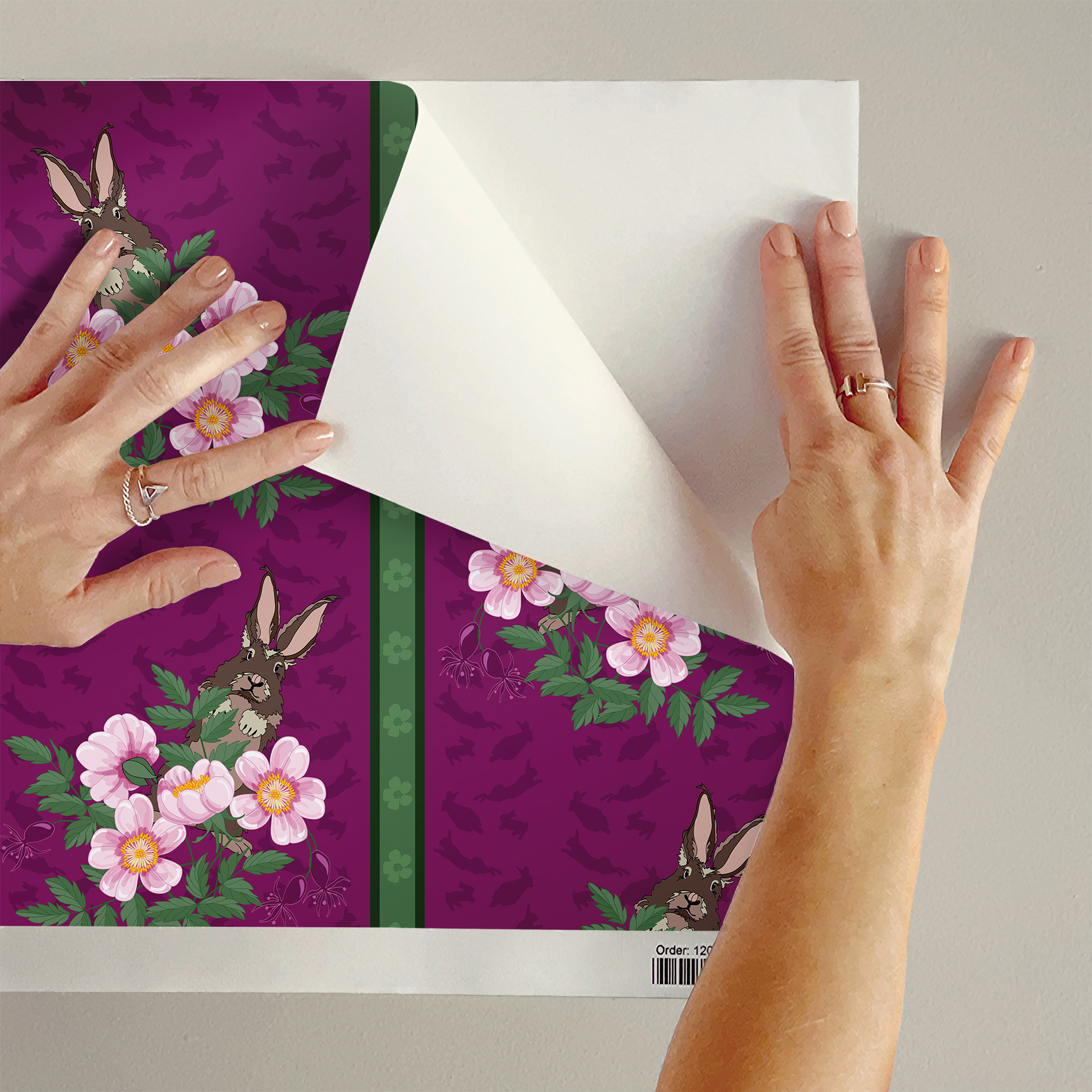 The artwork depicts a stylized brown hare partially concealed behind a cluster of green leaves and pink flowers with yellow centers. The background is dark green with subtle leafy patterns. Two vertical stripes—one dark purple and one green with small floral motifs—run along the left side, contrasting with the otherwise naturalistic elements. The composition balances the lively flora and fauna with a decorative, patterned design.